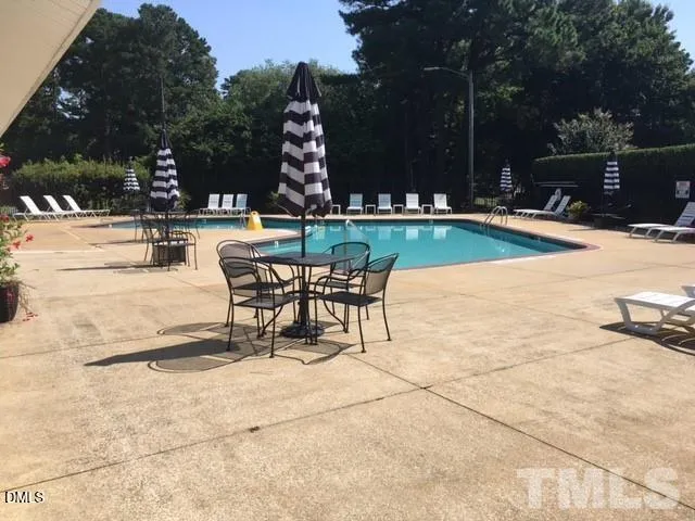 a swimming pool with outdoor seating and garden