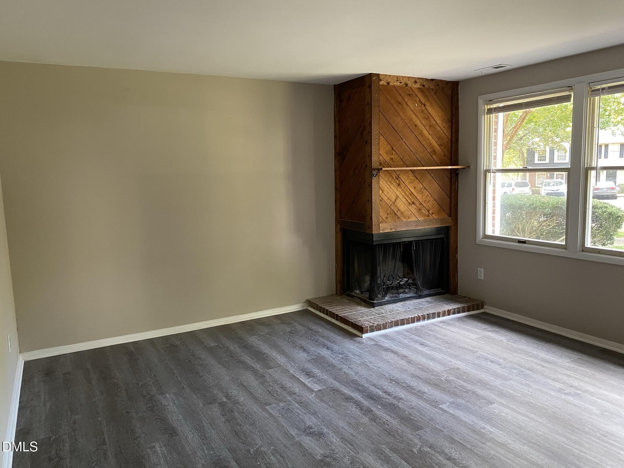 7708 Crown Crest Court Raleigh, NC 27615 - Photo 5 of 27 an empty room with wooden floor and windows