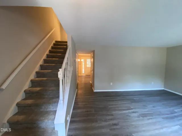 a view of entryway and hall with wooden floor