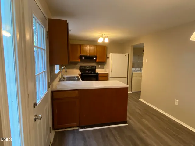 a kitchen with stainless steel appliances a refrigerator and a stove