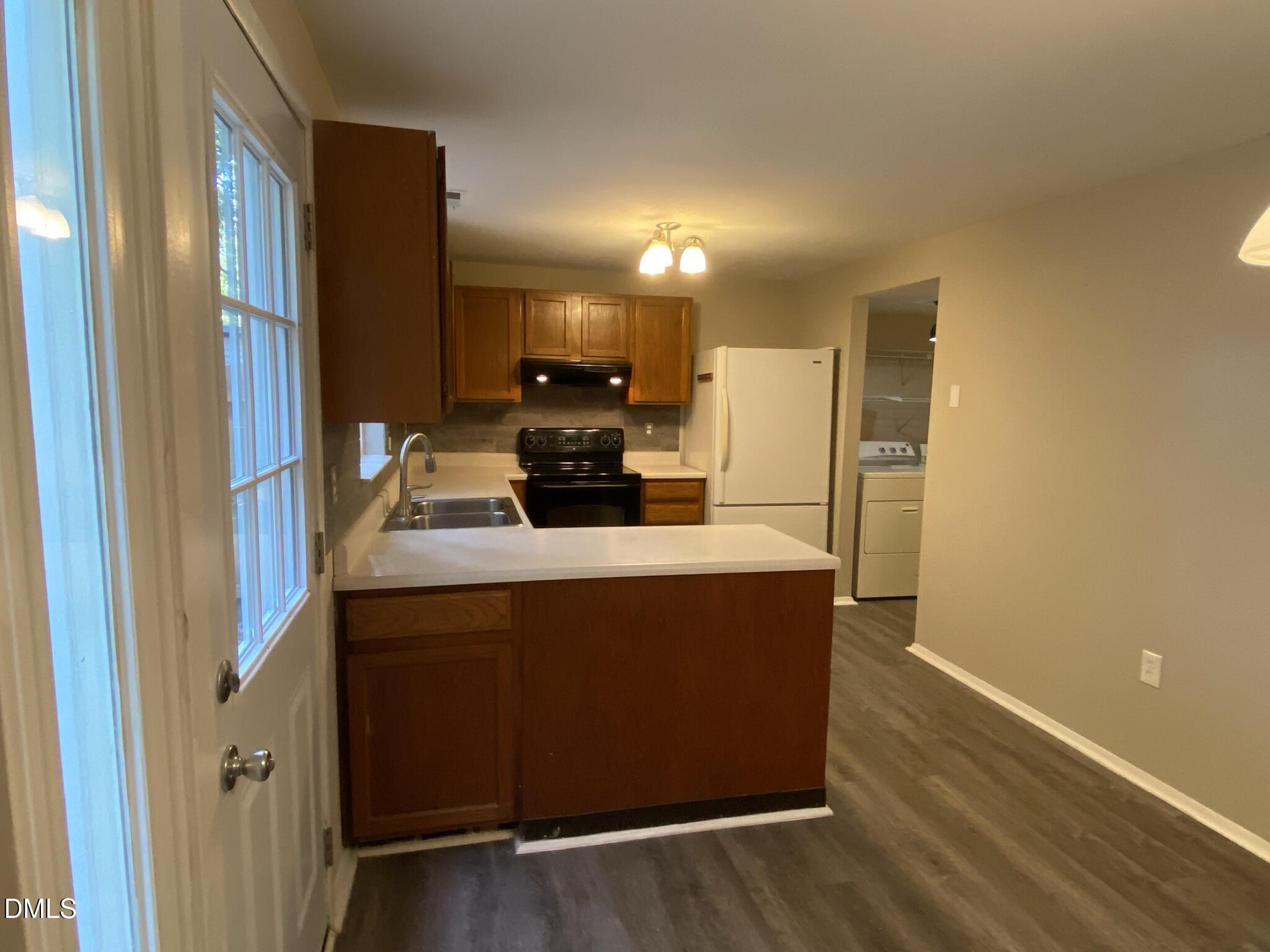 7708 Crown Crest Court Raleigh, NC 27615 - Photo 9 of 27 a kitchen with stainless steel appliances a refrigerator and a stove