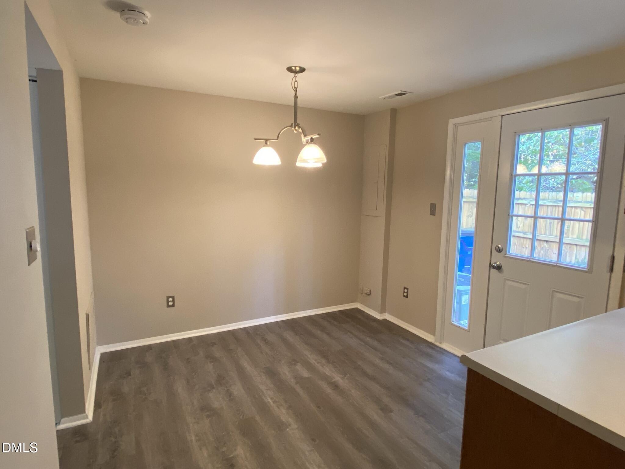 7708 Crown Crest Court Raleigh, NC 27615 - Photo 10 of 27 an empty room with wooden floor and windows