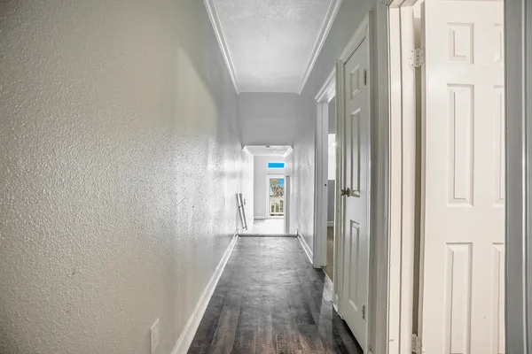 a view of a hallway with wooden floor