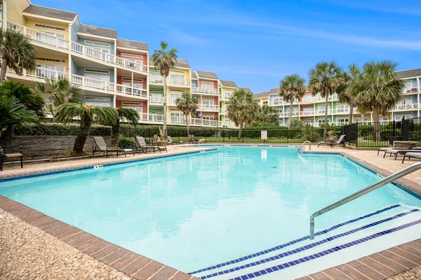 a view of a swimming pool with outdoor seating