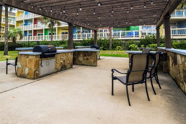 a patio area with table and chairs