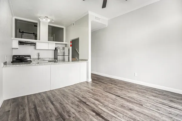 a kitchen with granite countertop a sink and cabinets
