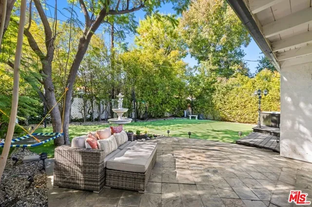 a patio with garden and furniture