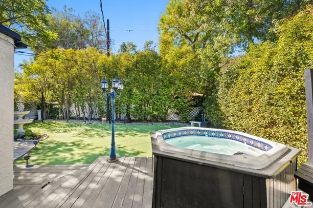 a view of a backyard with swimming pool