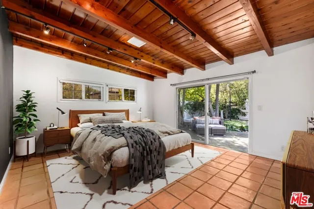 a bed room with a bed and a chair