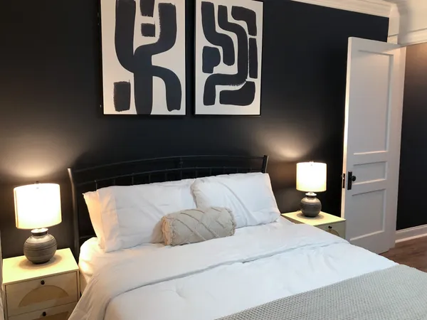 a bedroom with a bed and a lamp