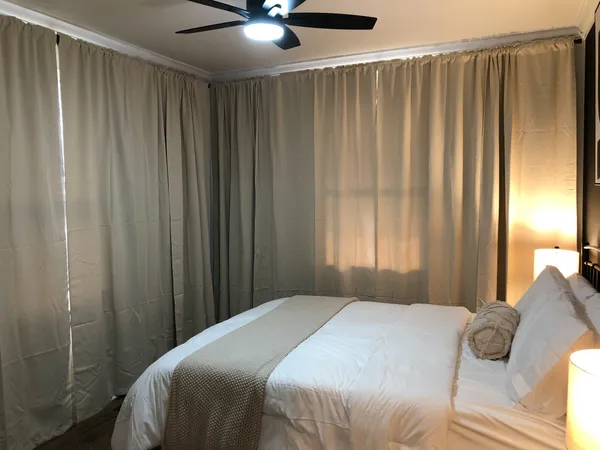 a bedroom with a bed and a window