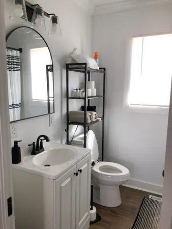 a bathroom with a toilet sink and mirror