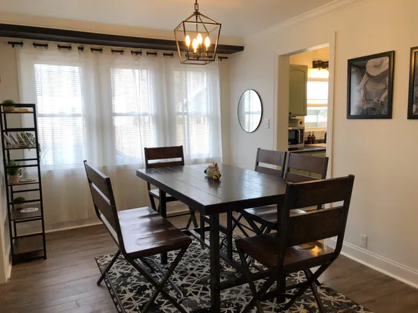 a view of a dining room with furniture and chandelier