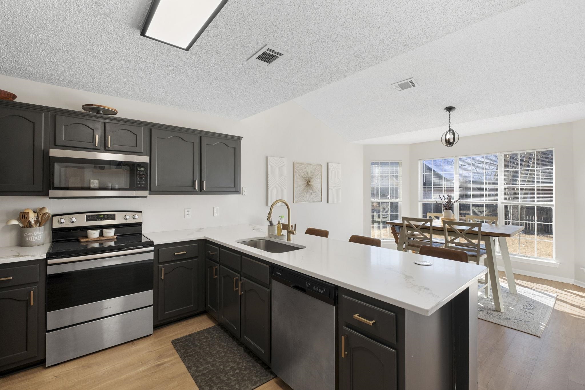 6411 Sandbourne West Olive Branch, MS 38654 - Photo 16 of 22 a kitchen with a sink and stainless steel appliances