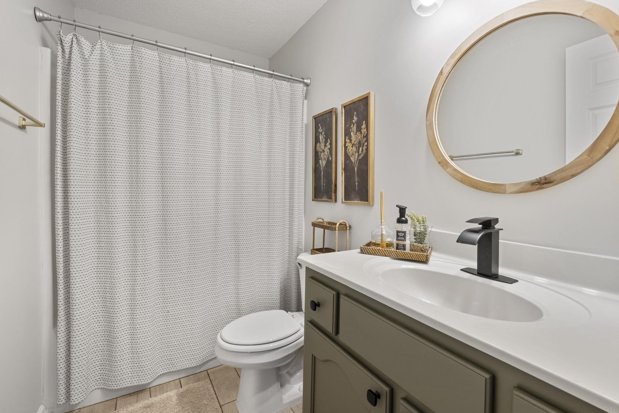 6411 Sandbourne West Olive Branch, MS 38654 - Photo 5 of 22 a bathroom with a sink a toilet and a mirror