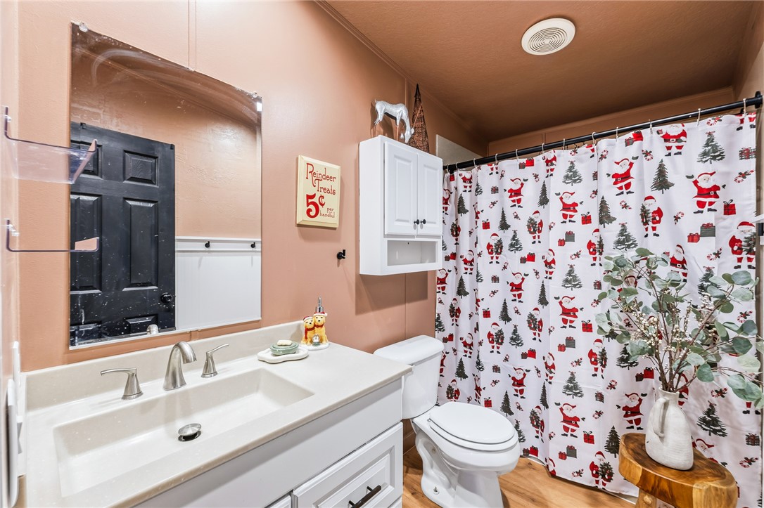 1996 Ramar Road Bullhead City, AZ 86442 - Photo 30 of 65 The bathroom features a vanity with a white countertop and a rectangular sink, complemented by a large wall-mounted mirror