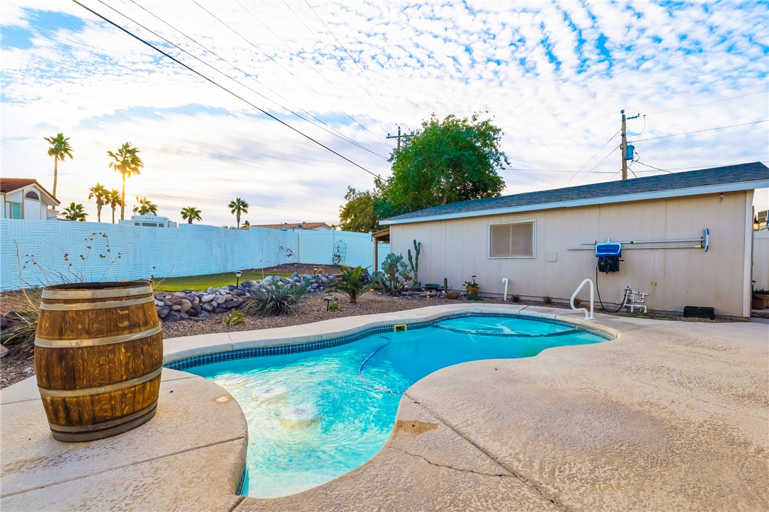 1996 Ramar Road Bullhead City, AZ 86442 - Photo 35 of 65 The property features a swimming pool with a surrounding concrete deck