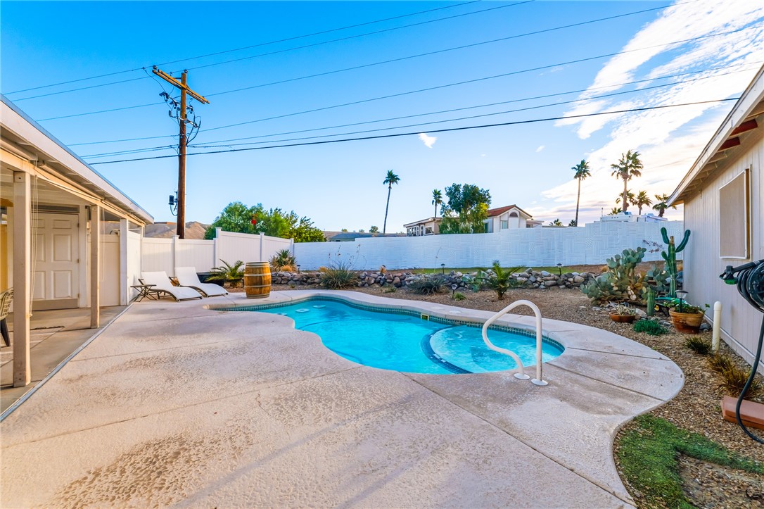 1996 Ramar Road Bullhead City, AZ 86442 - Photo 40 of 65 The property features a private swimming pool with a distinct shape and integrated steps