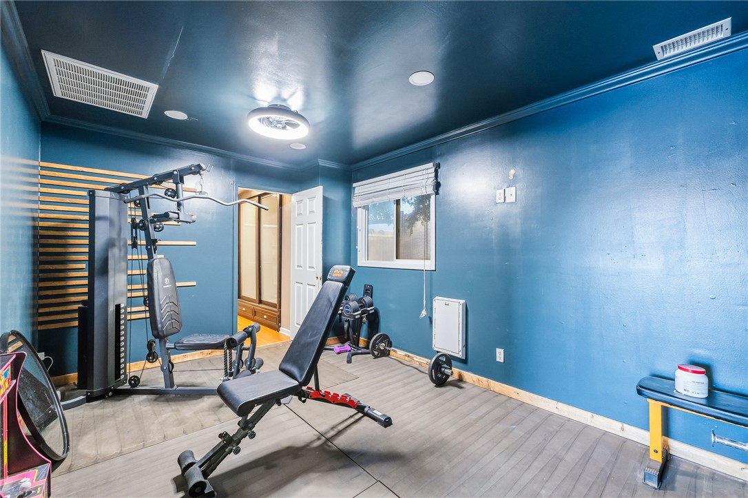 1996 Ramar Road Bullhead City, AZ 86442 - Photo 53 of 65 This versatile room features blue walls, wood-style flooring, a window with blinds, and recessed???????????????????????????????? lighting