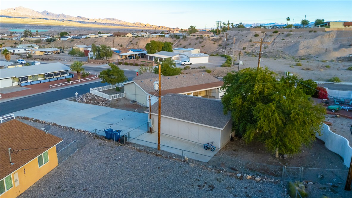 1996 Ramar Road Bullhead City, AZ 86442 - Photo 62 of 65 The property features a concrete driveway and a large, mature tree