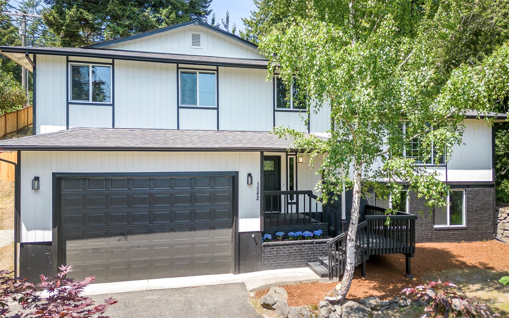 a front view of a house with a garden