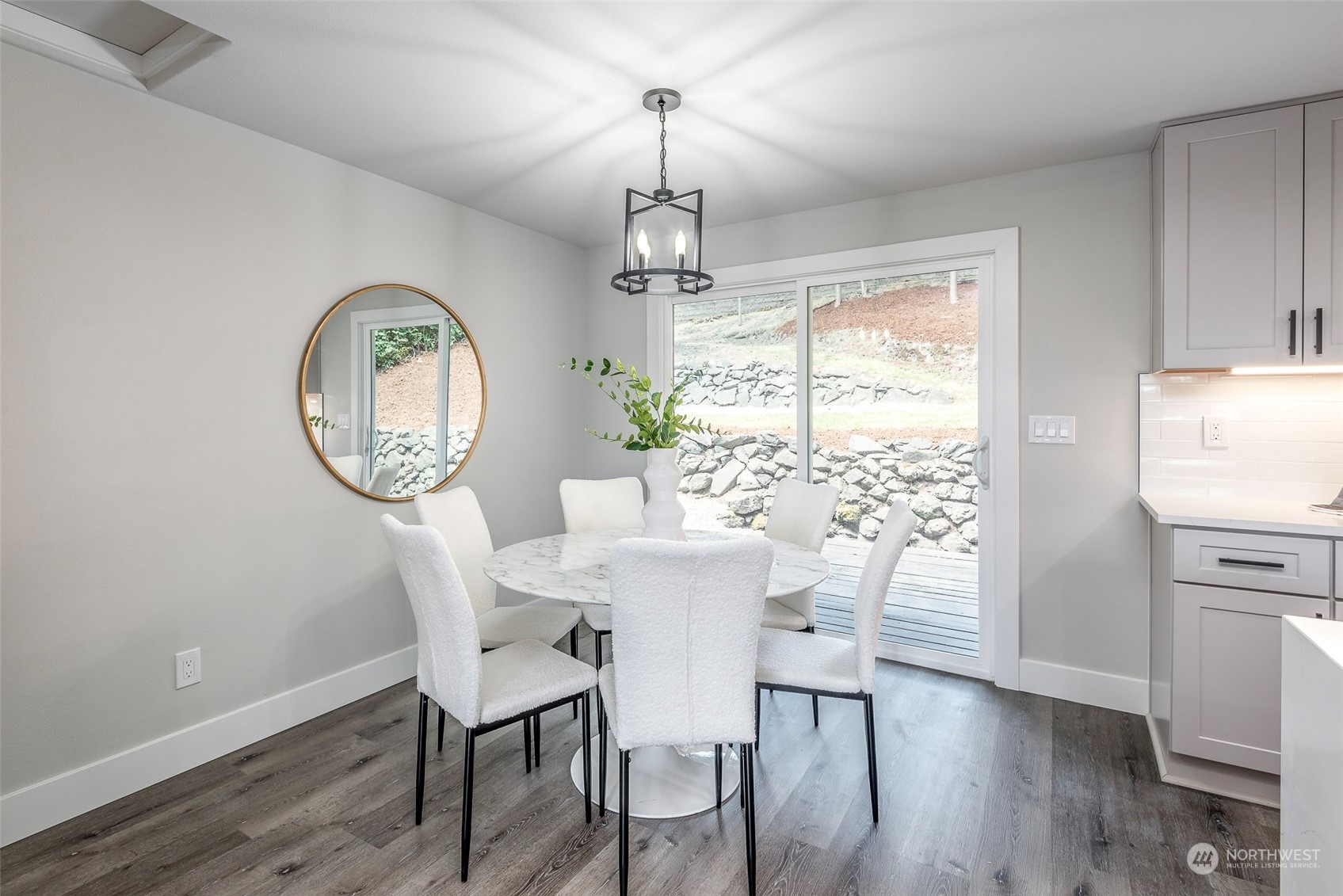 1582 Rainier Drive Fircrest, WA 98466 - Photo 17 of 40 a view of a dining room with furniture a chandelier and wooden floor