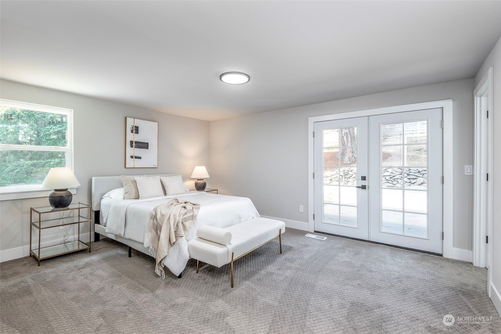 1582 Rainier Drive Fircrest, WA 98466 - Photo 26 of 40 a spacious bedroom with a bed and a large window