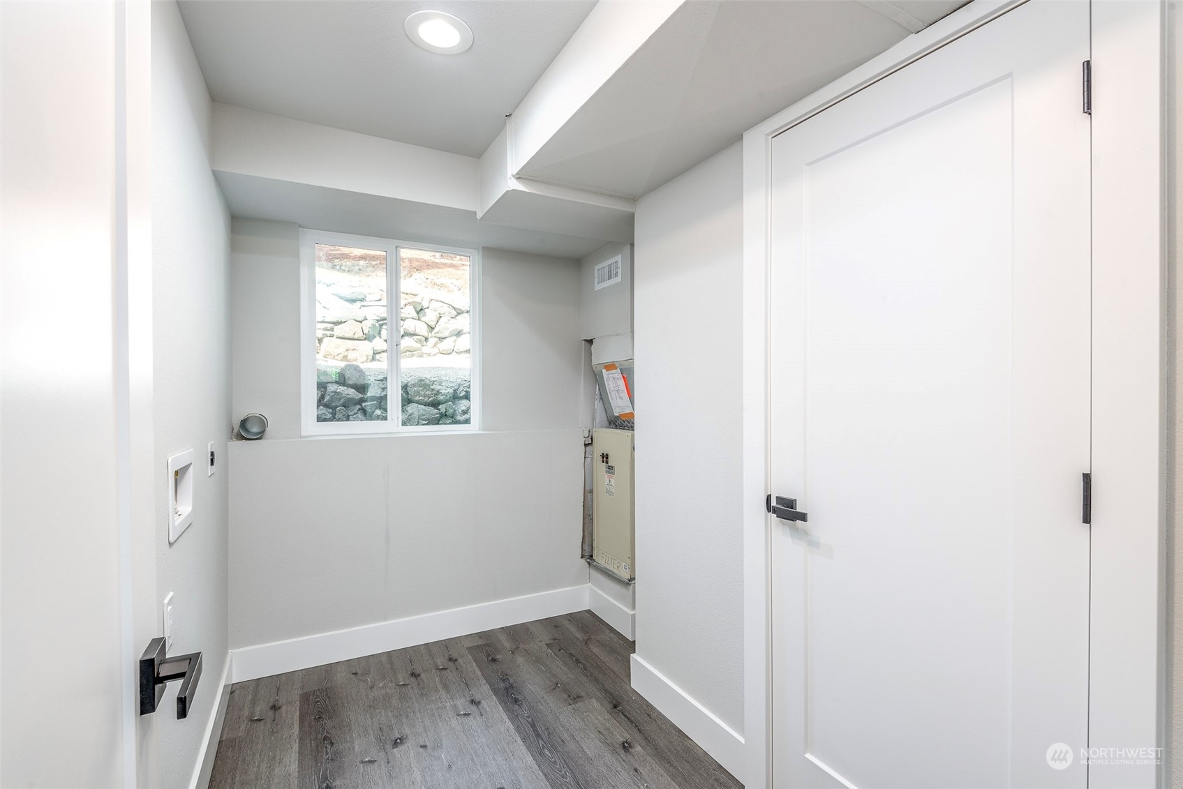 1582 Rainier Drive Fircrest, WA 98466 - Photo 34 of 40 a view of an empty room with wooden floor and a window