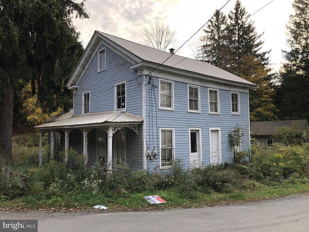 45 Grocery Hill Road Equinunk, PA 18417 - Photo 7 of 24 a front view of a house with plants and trees