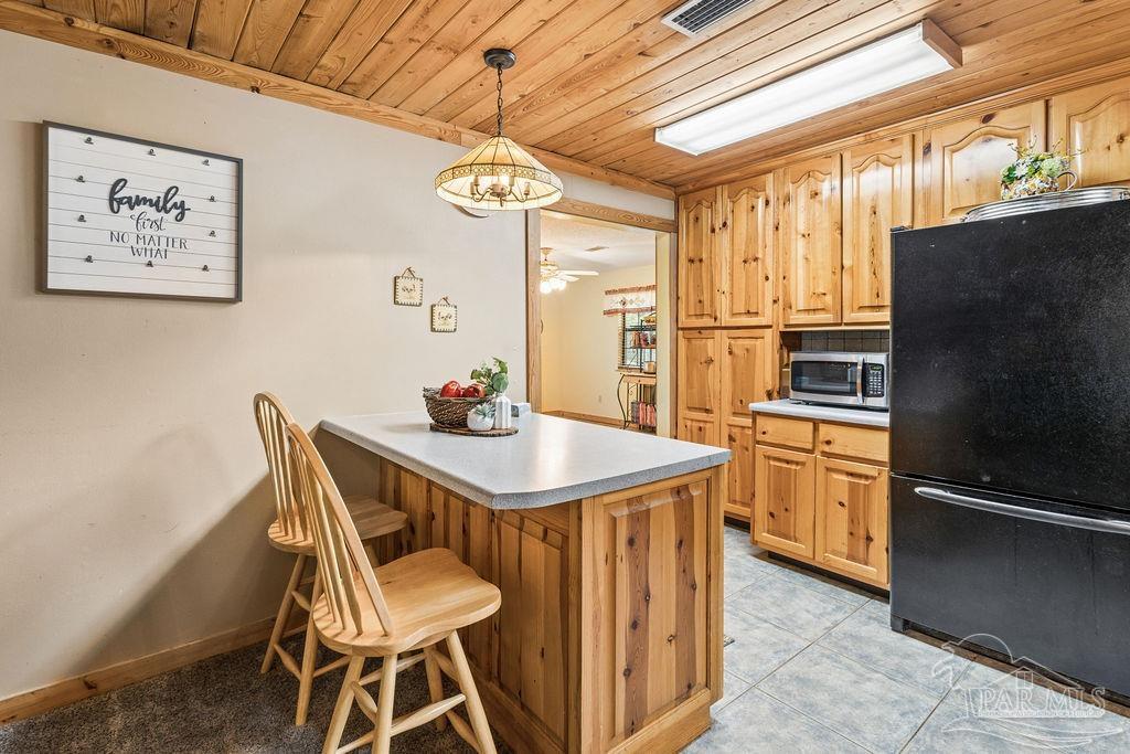 8938 Pioneer Road Holt, FL 32564 - Photo 9 of 44 a view of a dining room with furniture window and wooden floor