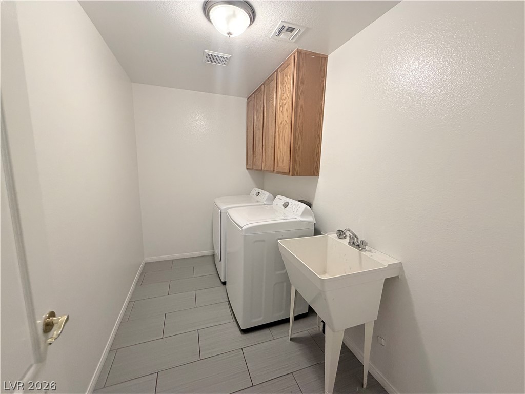 6116 Rabbit Track Street Las Vegas, NV 89130 - Photo 24 of 28 A well-appointed utility space features organized storage and convenient laundry facilities.