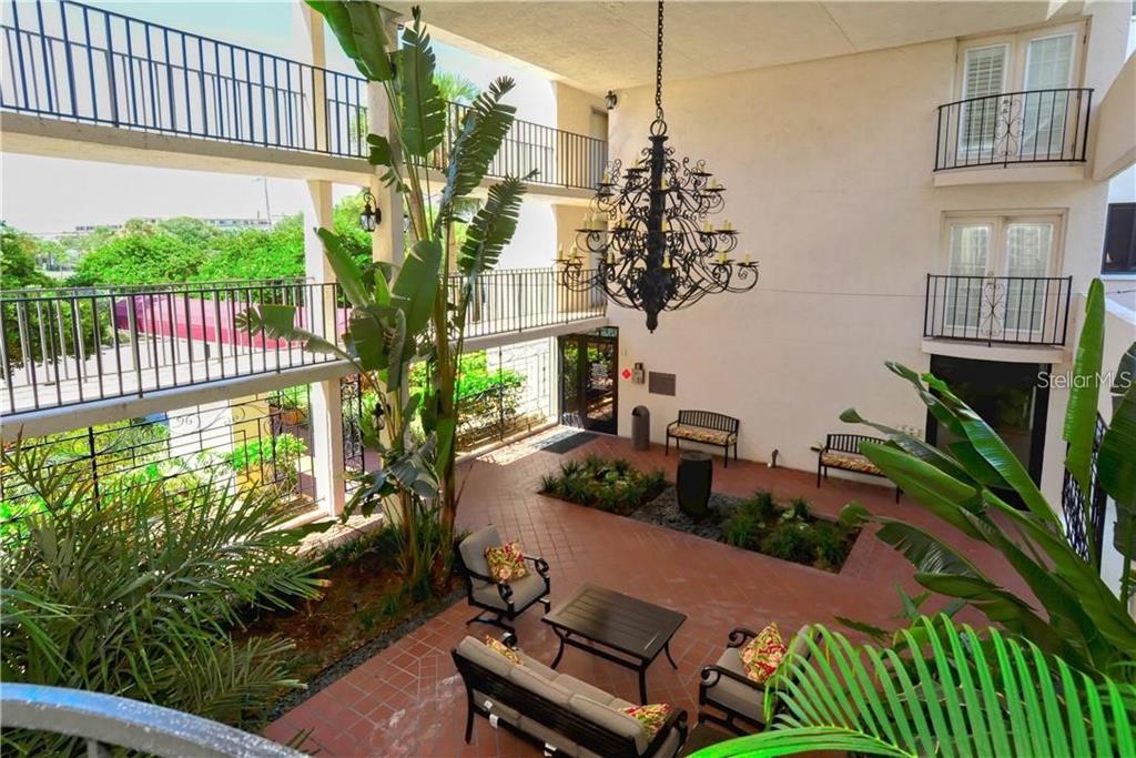 6285 Midnight Pass Road, Unit 403 Sarasota, FL 34242 - Photo 5 of 51 a view of a porch with chairs and potted plants