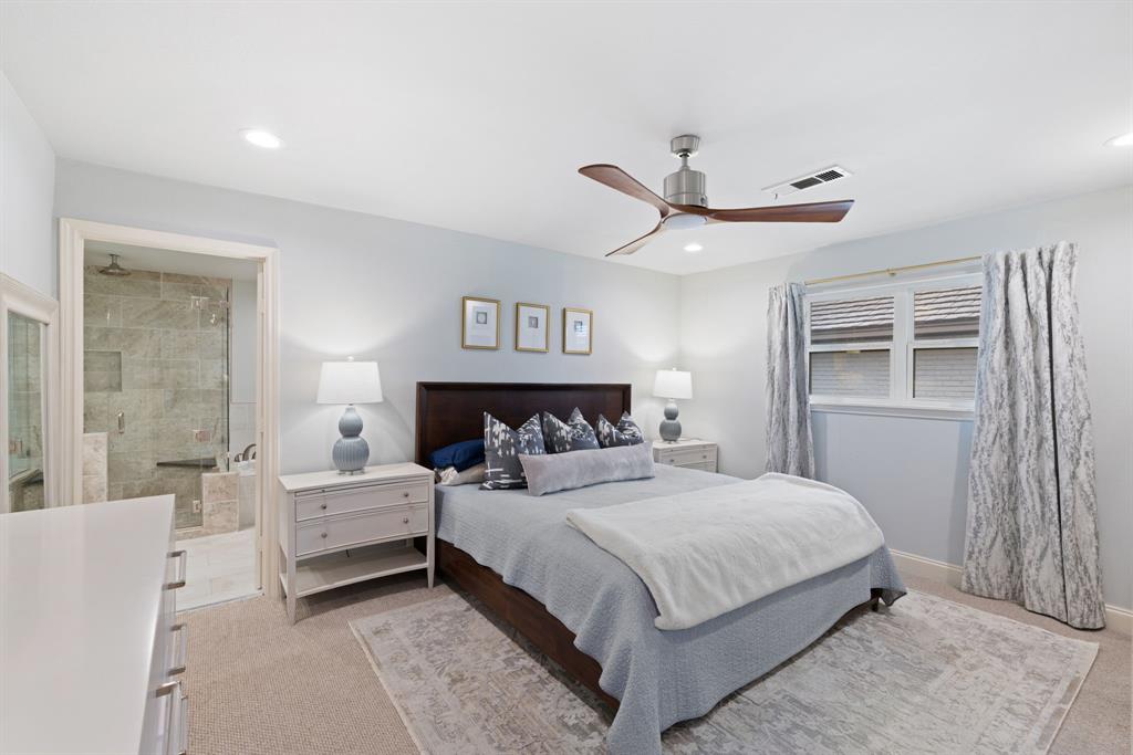 15935 Longvista Drive Dallas, TX 75248 - Photo 14 of 27 a bedroom with a large bed and a chandelier