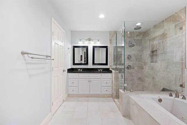 a spacious bedroom with a bed and a view of closet
