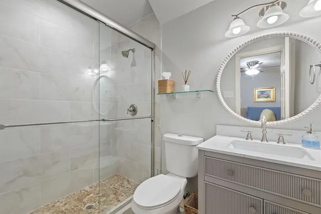 a bedroom with a bed a chandelier and a chair