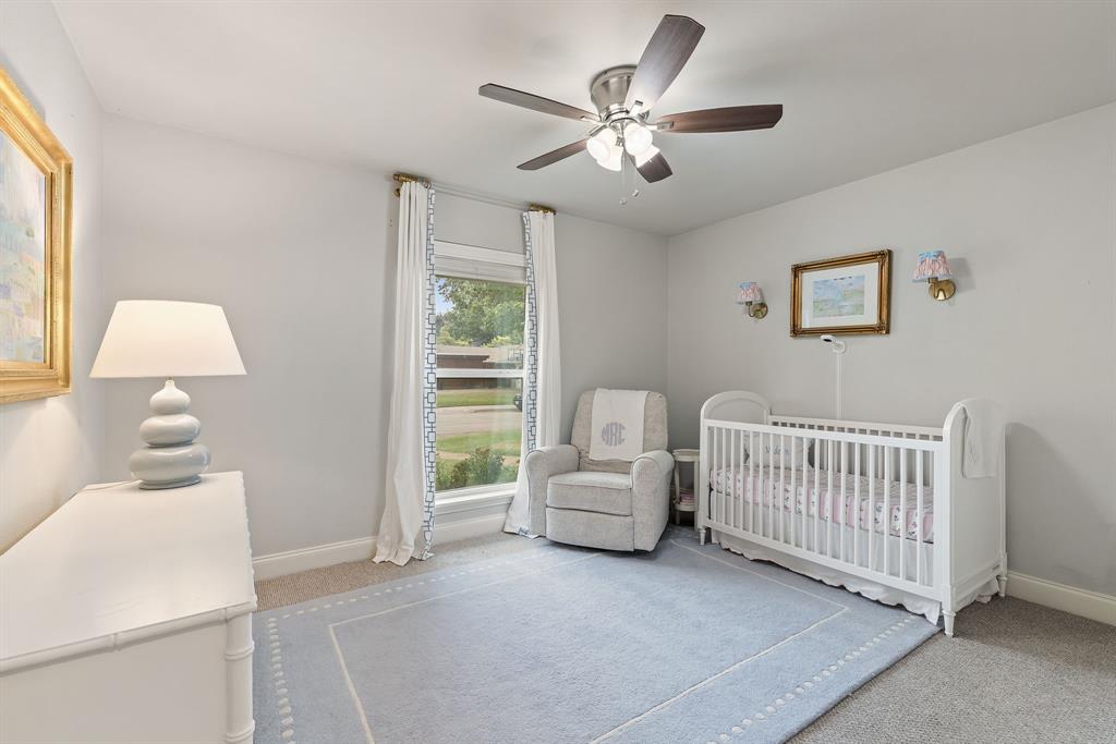 15935 Longvista Drive Dallas, TX 75248 - Photo 23 of 27 a bedroom with a bed and a window