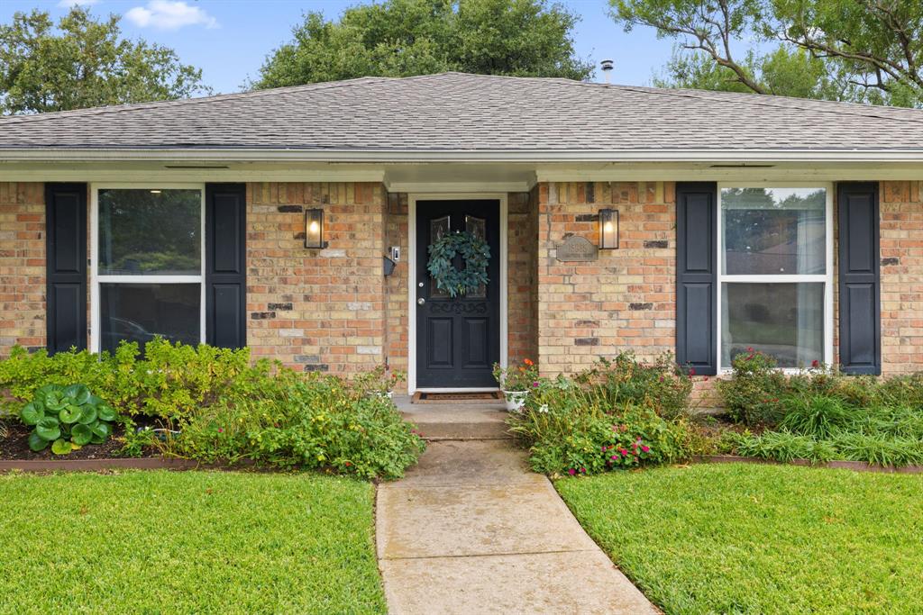 15935 Longvista Drive Dallas, TX 75248 - Photo 3 of 27 a front view of a house with garden