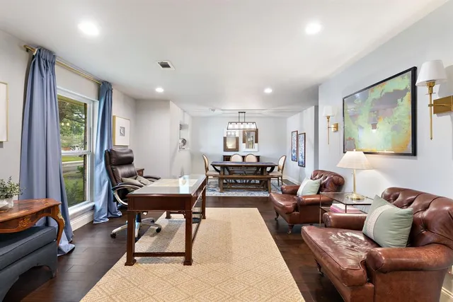 a living room with furniture a rug and a large window