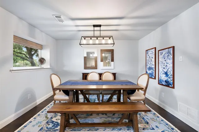 a dining room with furniture and window