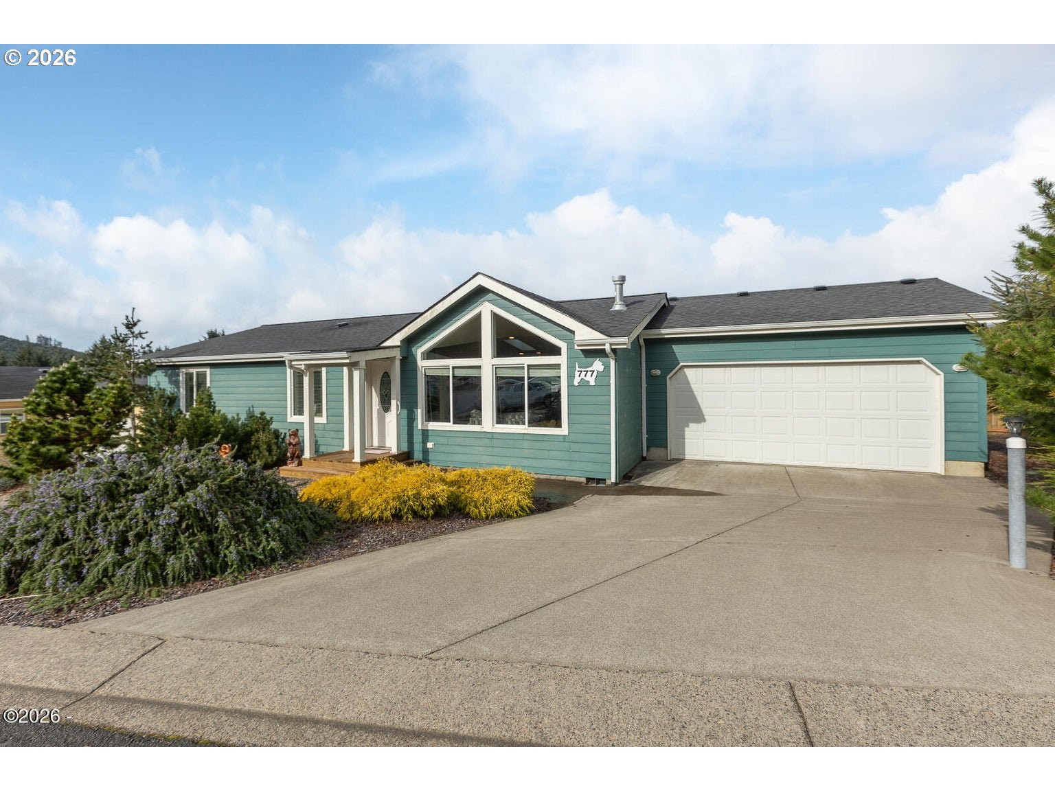 777 Southeast Winchell Street Depoe Bay, OR 97341 - Photo 1 of 29 a front view of a house with a yard and garage