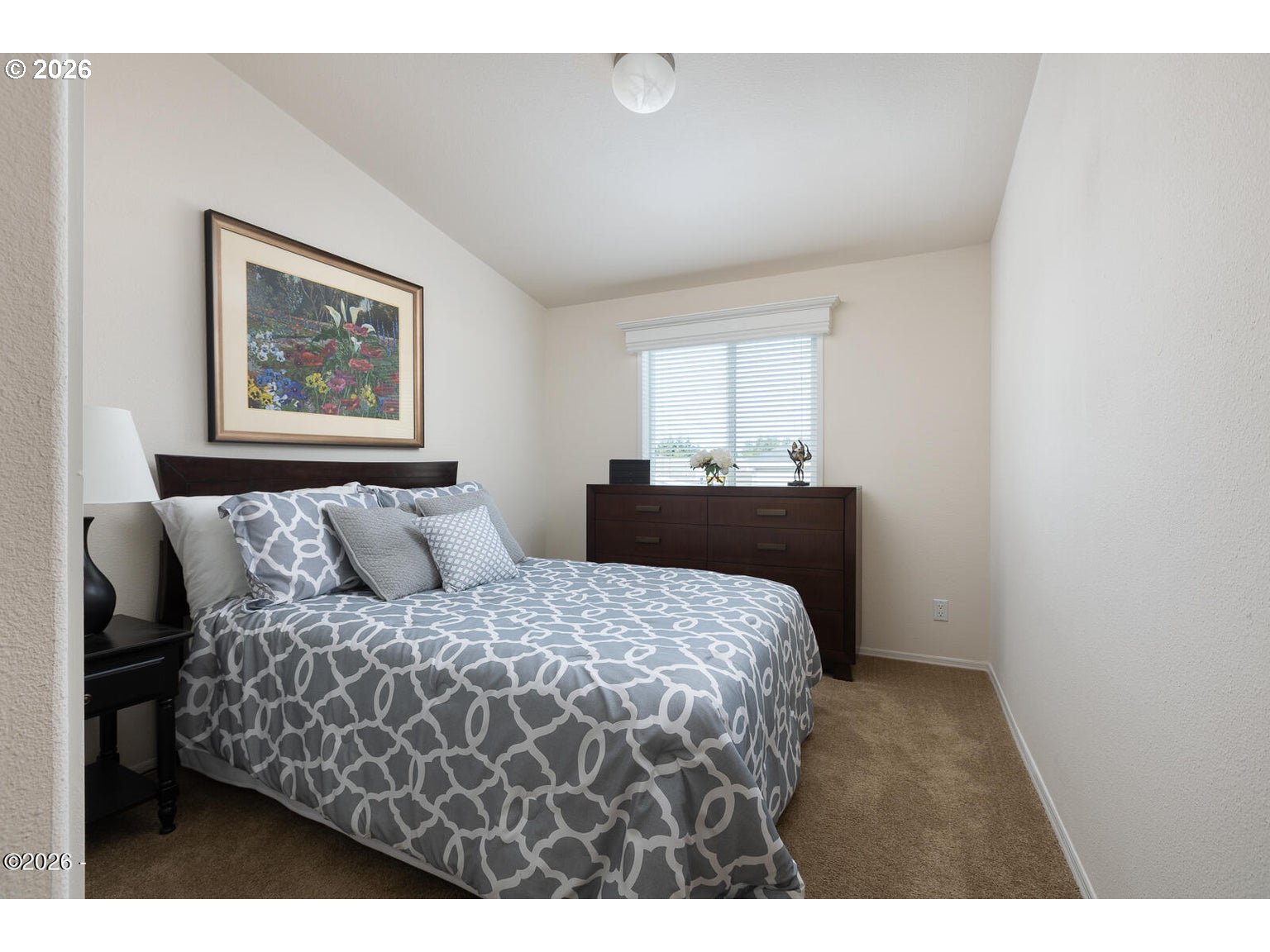 777 Southeast Winchell Street Depoe Bay, OR 97341 - Photo 15 of 29 a bedroom with a bed and a painting on the wall