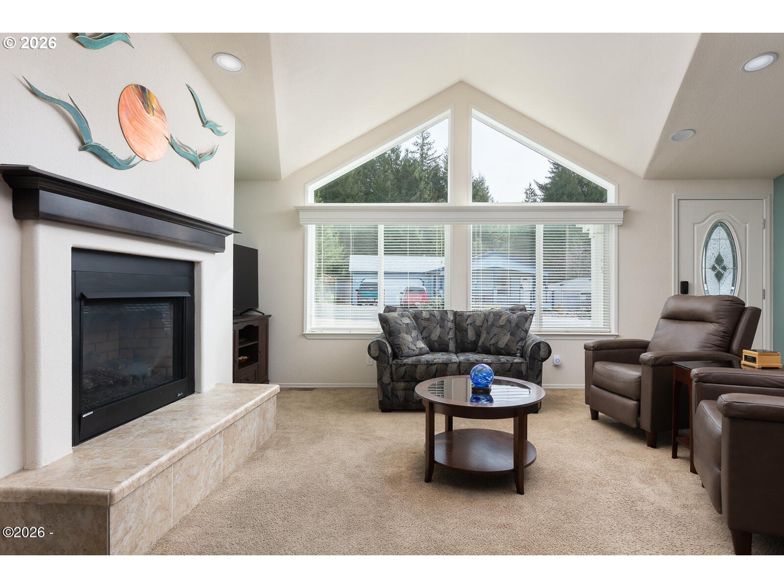 777 Southeast Winchell Street Depoe Bay, OR 97341 - Photo 5 of 29 a living room with furniture a window and a fireplace