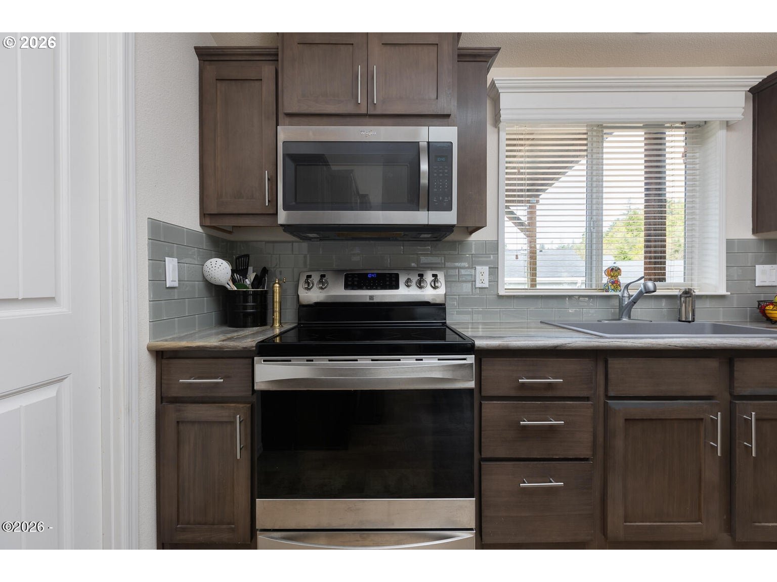777 Southeast Winchell Street Depoe Bay, OR 97341 - Photo 8 of 29 a kitchen with a stove and a microwave