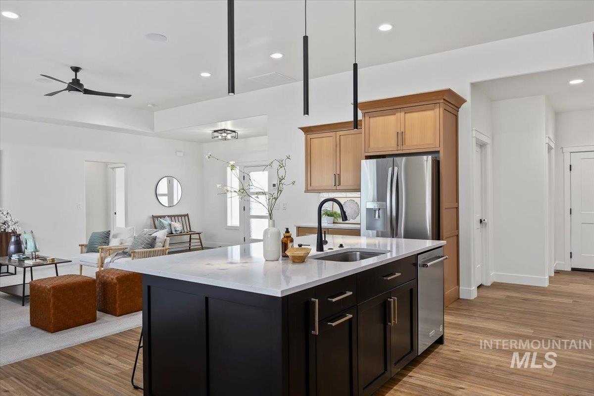 924 Trapper Peak Road Kimberly, ID 83341 - Photo 40 of 40 Kitchen with open floor plan, stainless steel appliances, a center island with sink, light wood-style floors, and recessed lighting