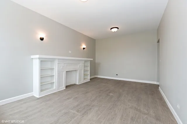 a view of an empty room with a closet and a window