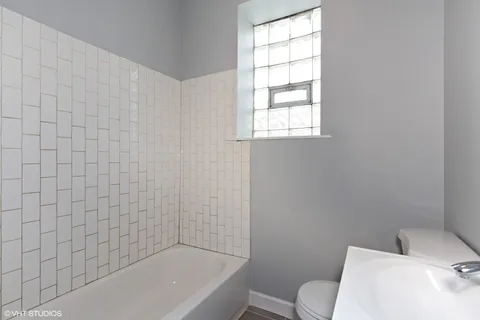 a bathroom with a toilet and bathtub