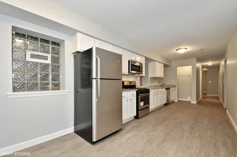 a kitchen with stainless steel appliances a refrigerator and a stove top oven