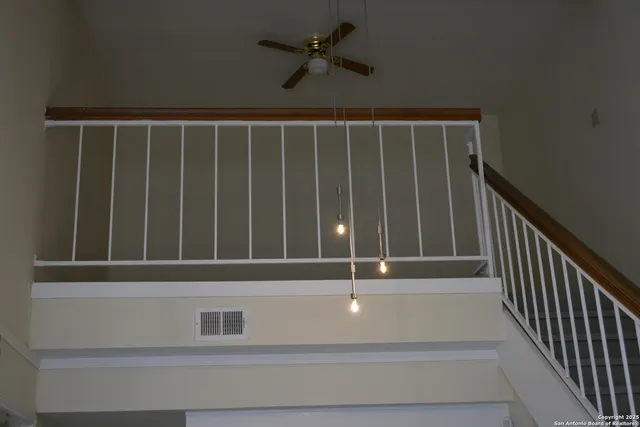 a view of staircase with white walls and a window