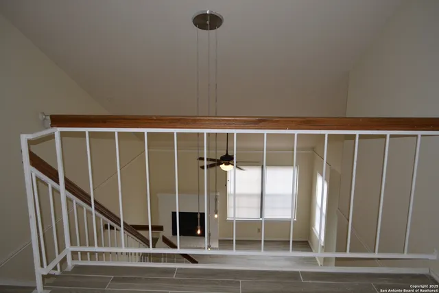 a view of a room with wooden floor