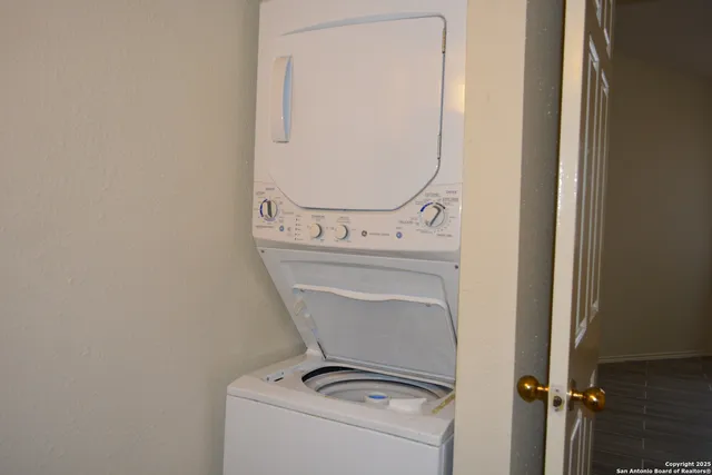 a close view of a utility room with dryer and washer